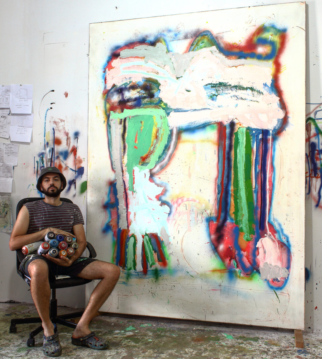 photograph of Marco Pariani in his Brooklyn studio with the painting Sometimes Legs, 2019